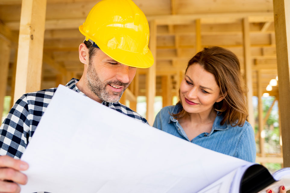 A woman talking to a contractor during her home build.