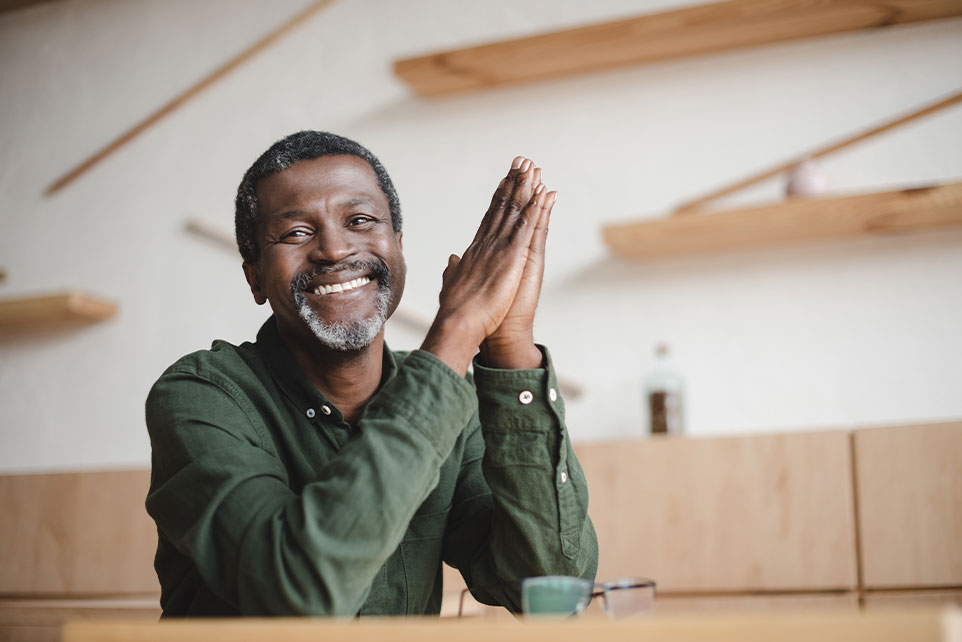 Man smiling after getting a personal line of credit.